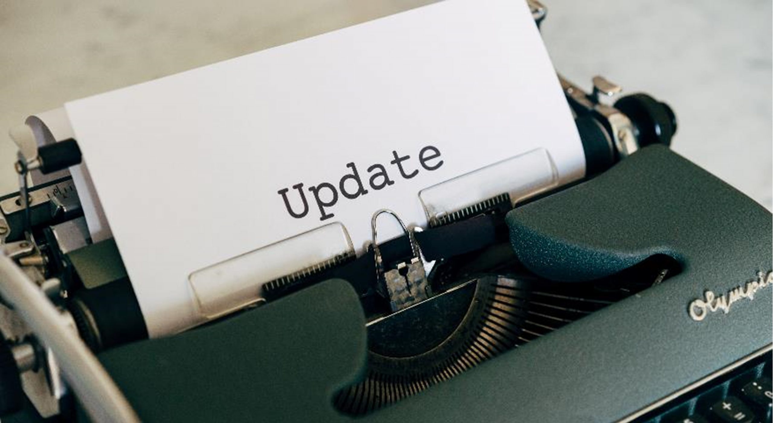 Typewriter with paper and the word 'update' typed on it